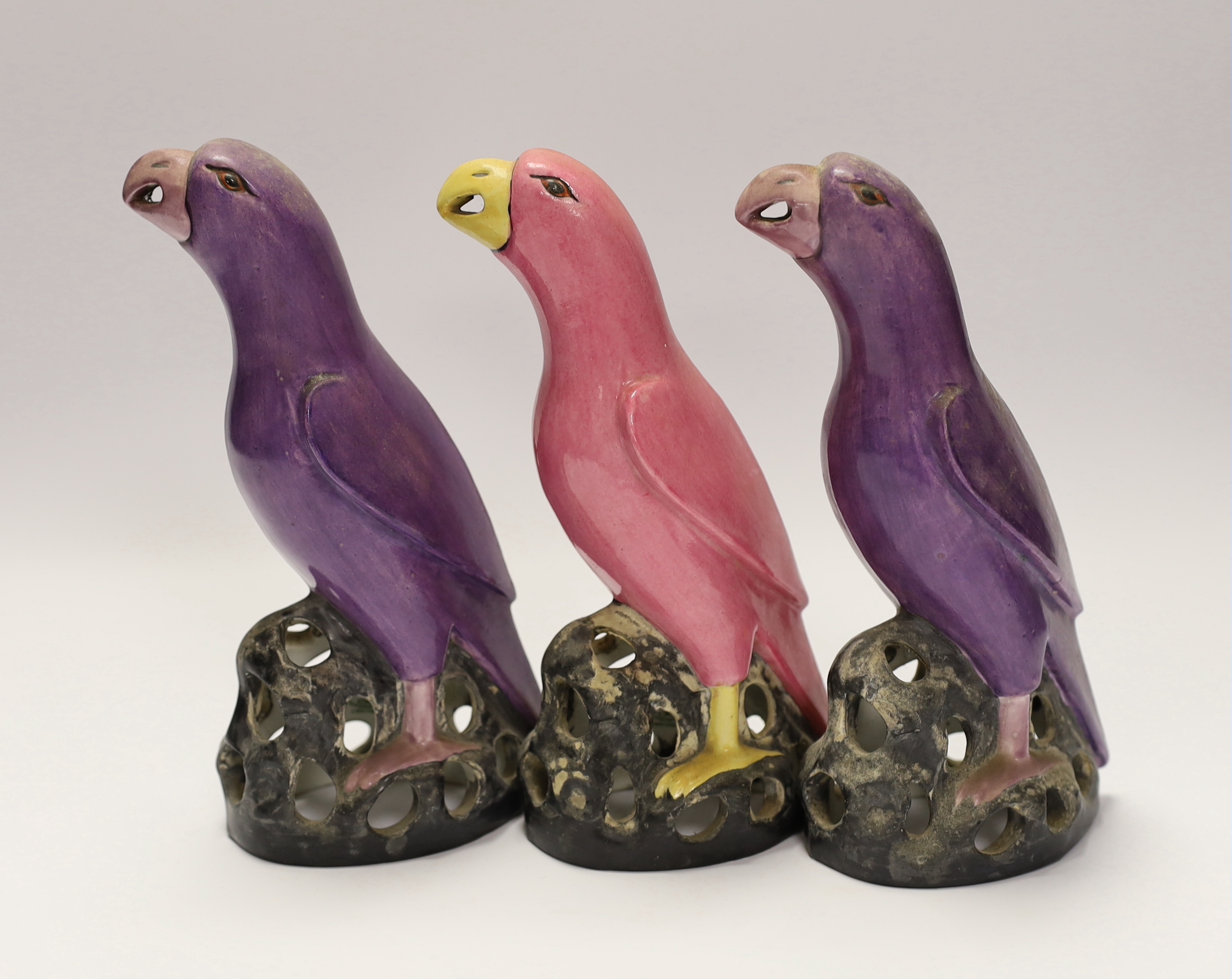 Three Crown Staffordshire parrots with purple and pink glazed, each stamped, 19cm high